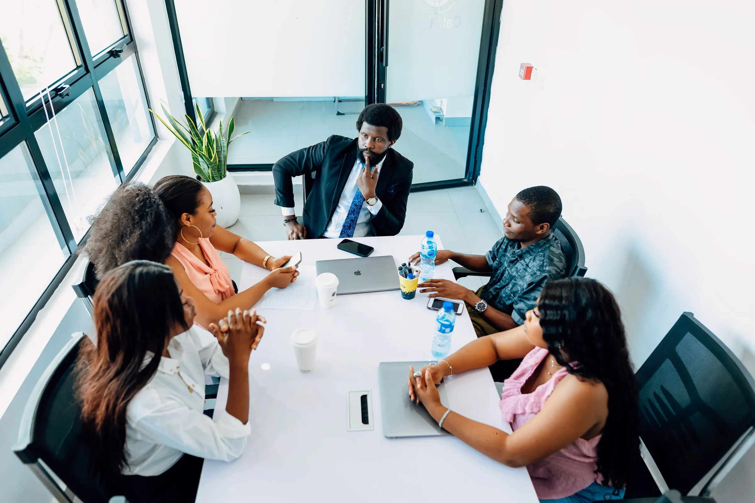 A team of professionals meeting around a boardroom table