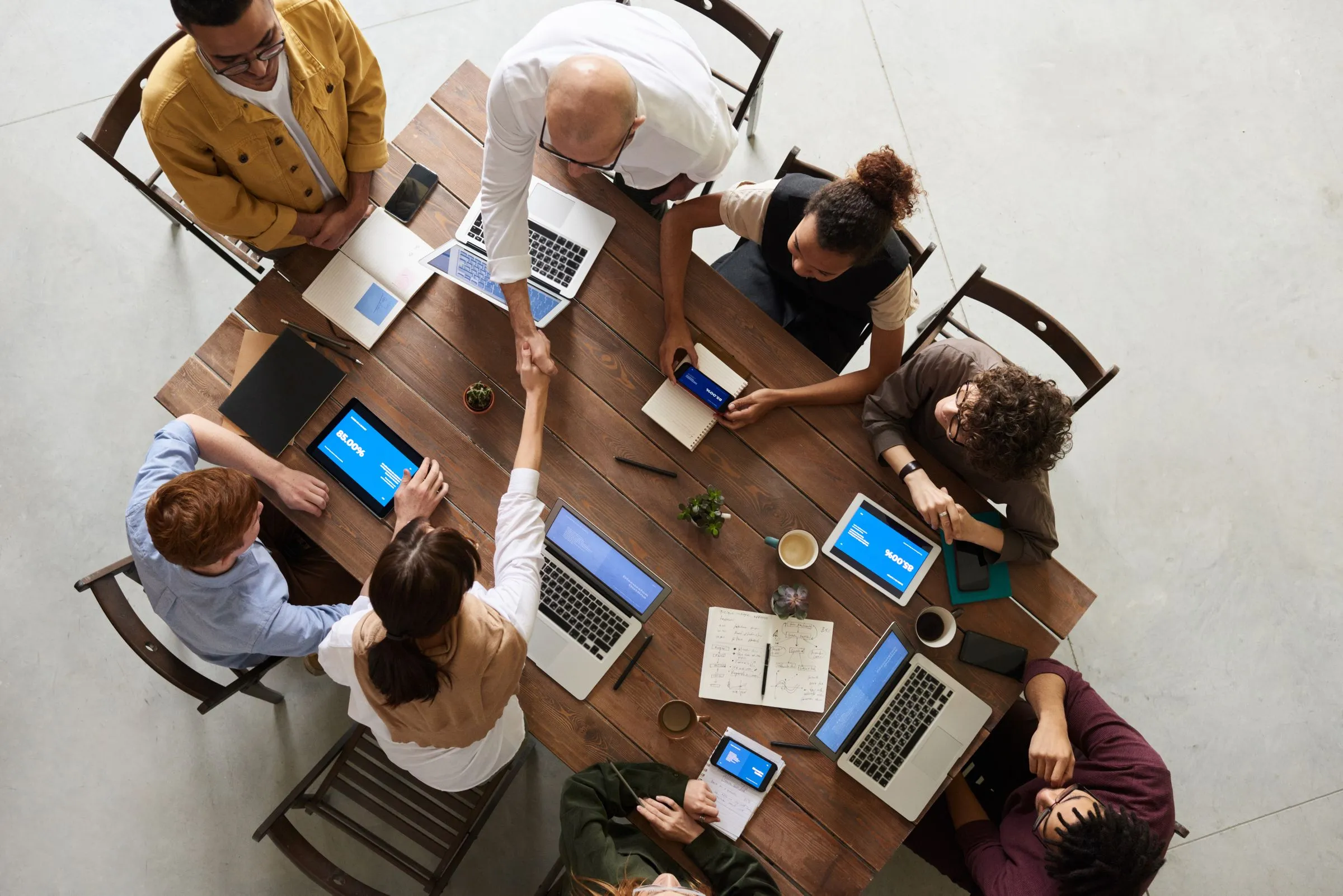 A team working together around a large table, seen from above